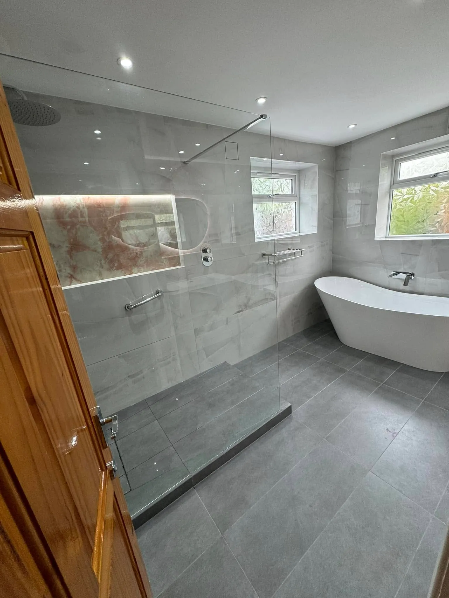 View from the doorway taking in the walk-in shower and bath together
