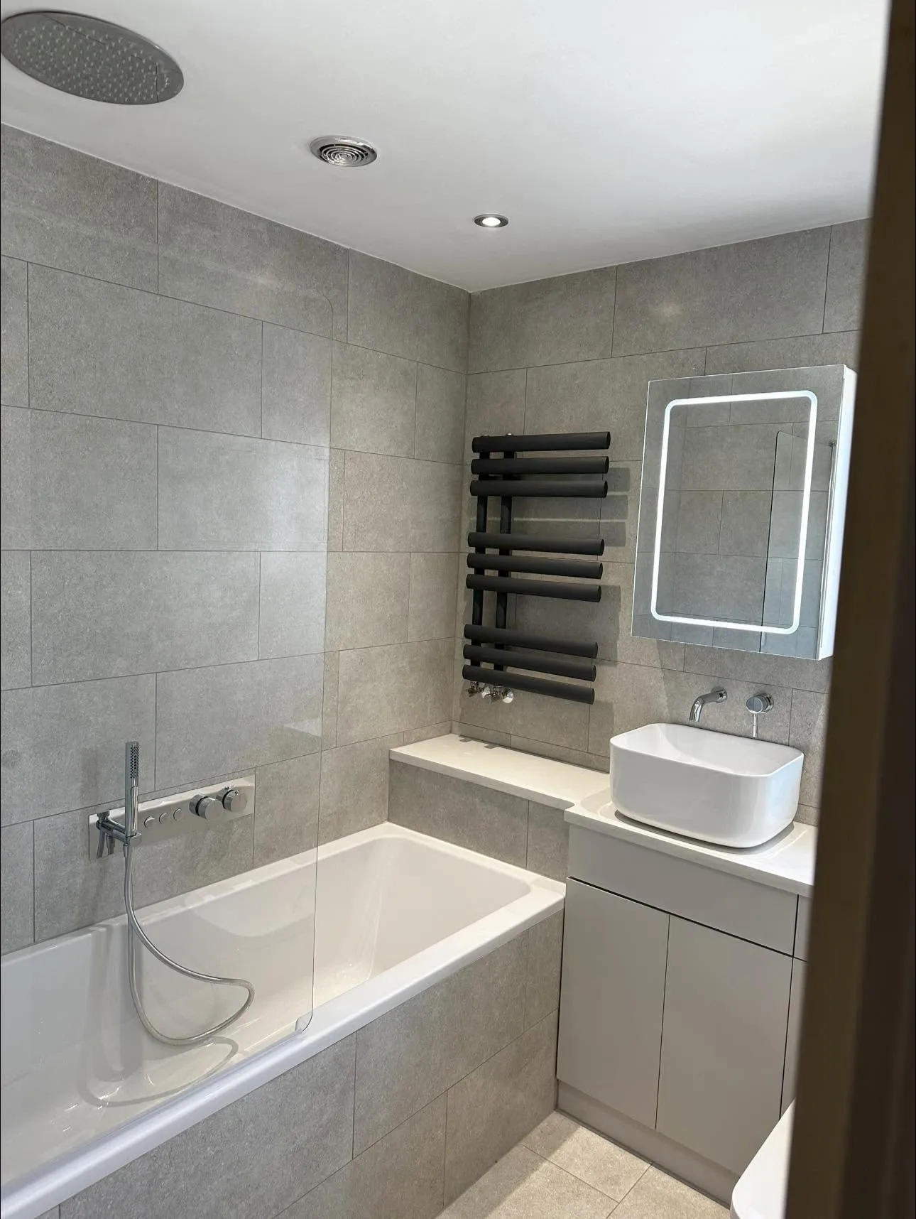 Bath, vanity and matt black radiator