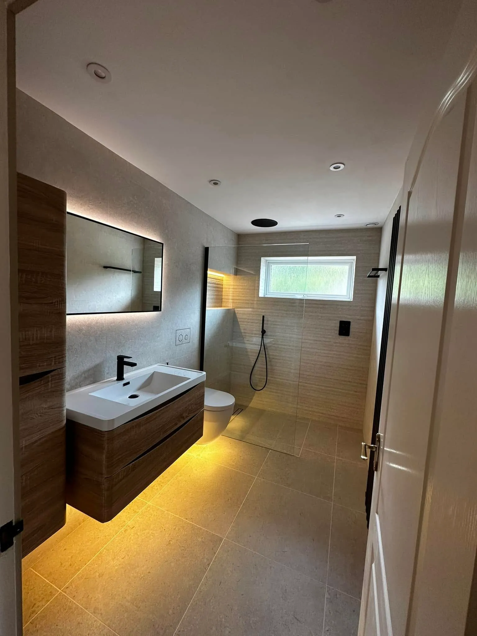 Second wide view including the door and shower enclosure