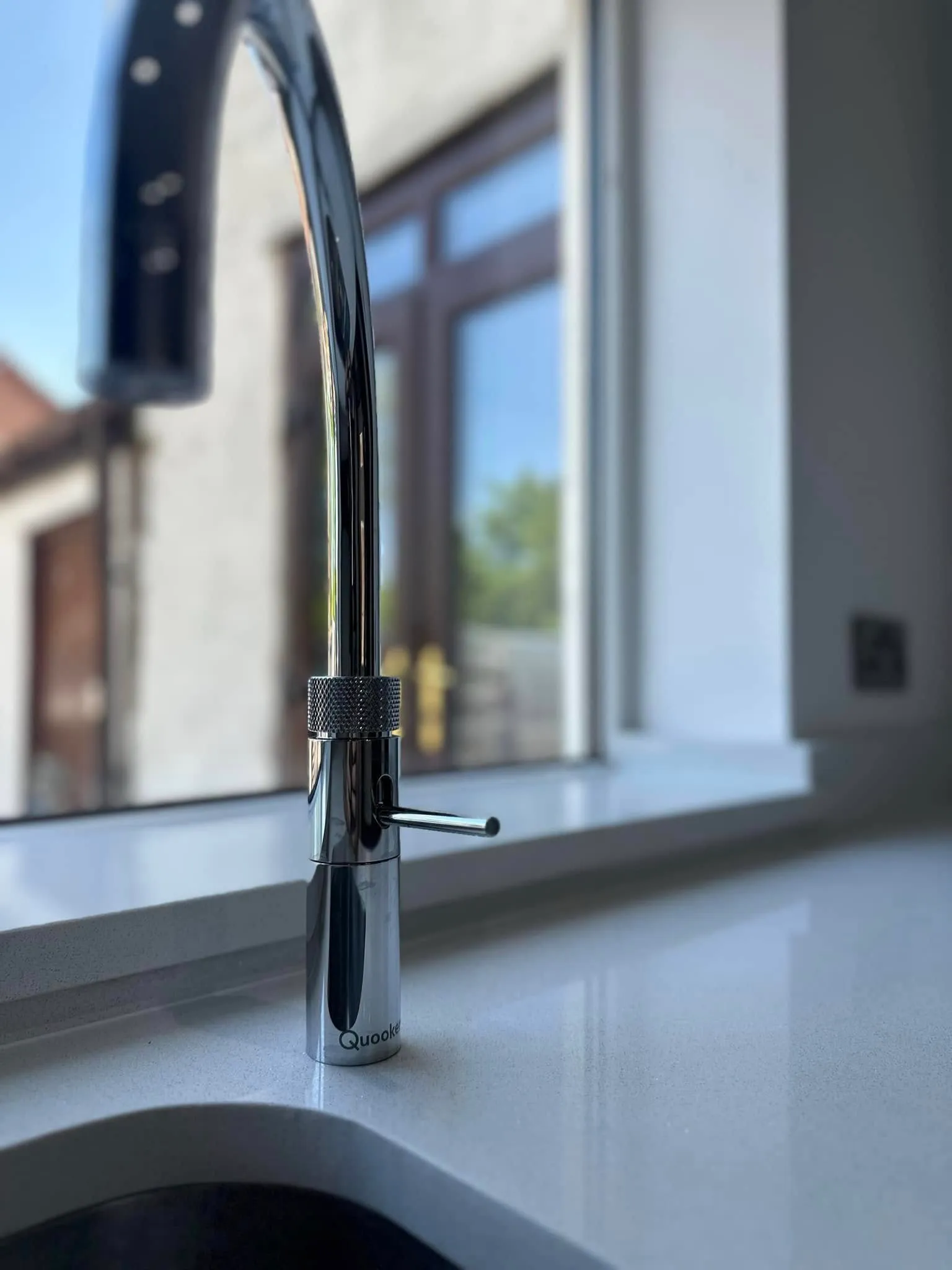 Boiling-water tap detail on white quartz