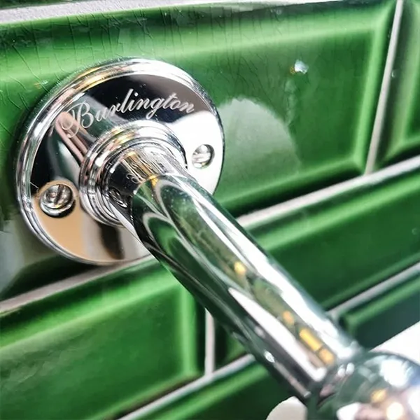 Chrome wall bracket detail on racing-green crackle-glazed metro tiles